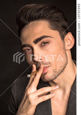 Model man smoking in studio Model man smoking in studio 19795949