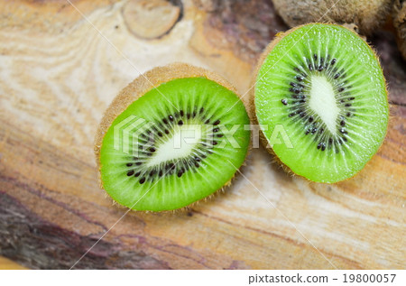 Halved kiwi on a wooden board Halved kiwi on a wooden board 19800057
