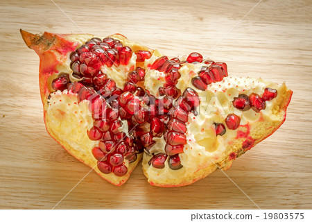 Delicious pomegranate fruit on wooden background 19803575