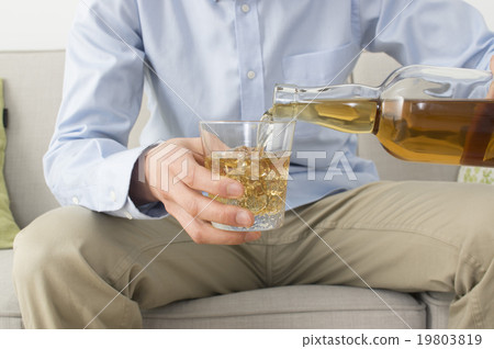 A man poured whiskey 19803819