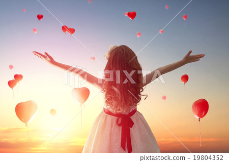 girl looking at red balloons 19804352