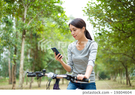 Asian Young woman looking at the cellphone for check the routine Asian Young woman looking at the cellphone for check the routine 19804604