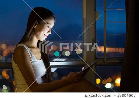 Woman use of cellphone at night 19804605