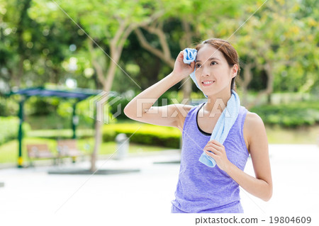 Young woman using blue towel after doing sport exercise 19804609