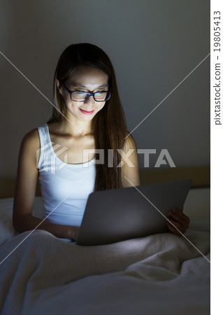 Woman working at home with notebook computer Woman working at home with notebook computer 19805413
