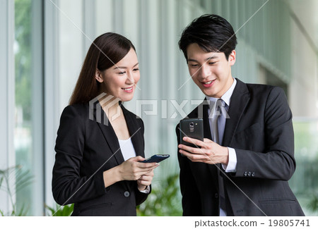 Business partner discuss about the detail on smartphone Business partner discuss about the detail on smartphone 19805741