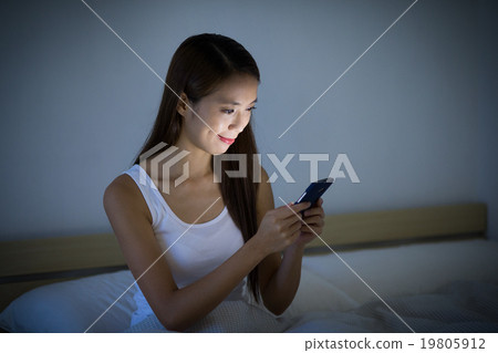 Woman using cellphone at night 19805912