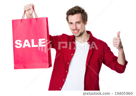 Happy man shopping with his thumbs up and showing a word sale 19805960