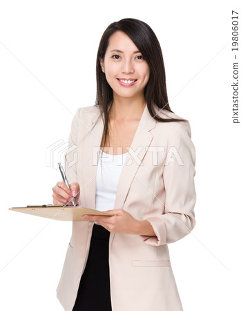 Young businesswoman write on clipboard Young businesswoman write on clipboard 19806017