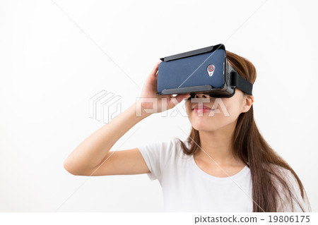 Young woman watching though the VR device Young woman watching though the VR device 19806175