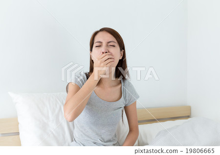 Asian woman yawning on the bed Asian woman yawning on the bed 19806665