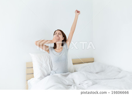 Woman waking up in her bedroom Woman waking up in her bedroom 19806666