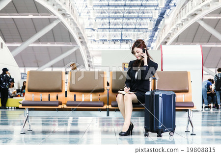 Business woman contacting at the lounge of the international terminal Business woman contacting at the lounge of the international terminal 19808815
