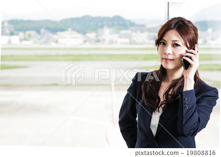 Contact the business woman in front of the airport runway Contact the business woman in front of the airport runway 19808816