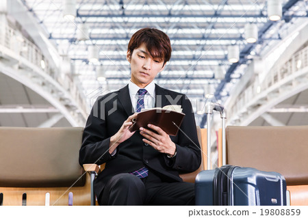 觀看筆記本的商人在機場大廳 觀看筆記本的商人在機場大廳 19808859