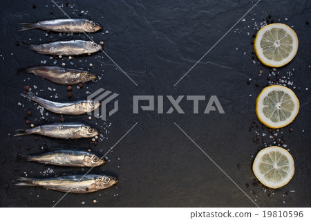 Small fishes with lemon on the table 19810596