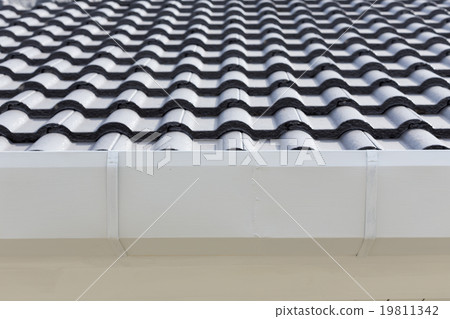 white gutter on the roof top of house 19811342