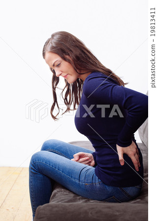 Young Woman Sitting and Suffering From Ache Young Woman Sitting and Suffering From Ache 19813411