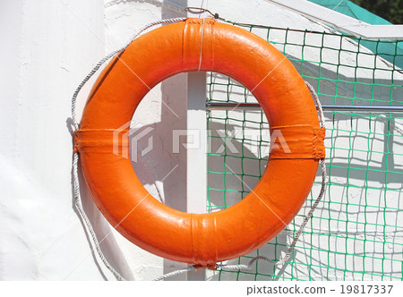Orange lifebuoy on white ship board. Orange lifebuoy on white ship board. 19817337
