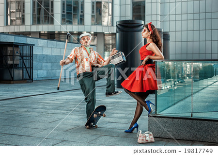 Past girl rides an old man on a skateboard. Past girl rides an old man on a skateboard. 19817749