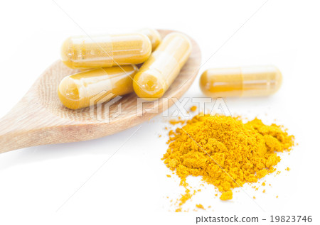 Turmeric powder and a wooden spoon. Turmeric powder and a wooden spoon. 19823746
