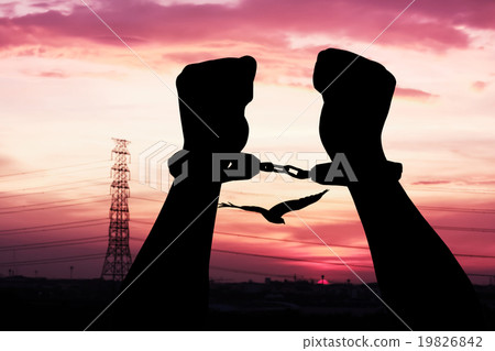 silhouette of hand in shackle on sunset in city silhouette of hand in shackle on sunset in city 19826842
