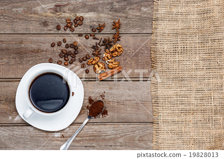 The cup of coffee on wooden table The cup of coffee on wooden table 19828013