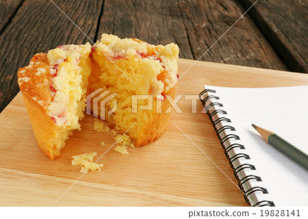 Delicious blueberry muffin on old wooden planks Delicious blueberry muffin on old wooden planks 19828141