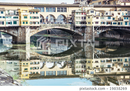 Ponte Vecchio is mirrored in the river Arno, Florence, Italy, cu Ponte Vecchio is mirrored in the river Arno, Florence, Italy, cu 19838269
