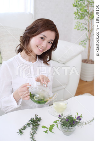 A young woman drinking herbal tea 19839150