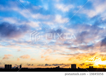 sunset sky with clouds over urban houses in winter sunset sky with clouds over urban houses in winter 19845056