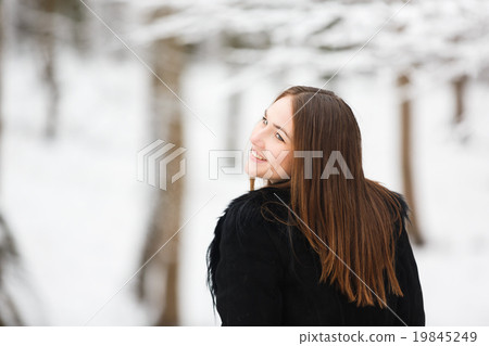 Young happy woman in winter park Young happy woman in winter park 19845249