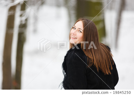 Young happy woman in winter park Young happy woman in winter park 19845250