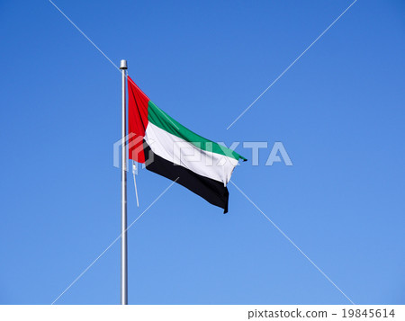 The national flag of the United Arab Emirates that fainting in the clear sky The national flag of the United Arab Emirates that fainting in the clear sky 19845614
