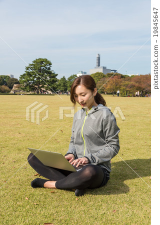 A young woman operating a laptop 19845647