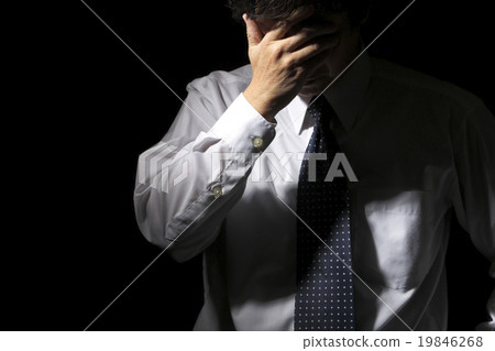 Middle-aged businessman holding a head Middle-aged businessman holding a head 19846268