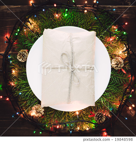 Christmas gift on the plate in wreath 19848598