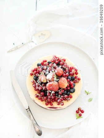 Cheesecake with fresh garden berries on top over Cheesecake with fresh garden berries on top over 19849209