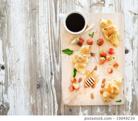 Freshly baked almond croissants with garden Freshly baked almond croissants with garden 19849210