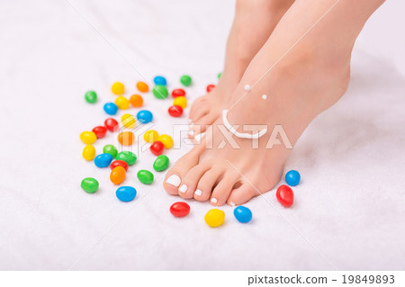 Nice woman applying cream on her legs Nice woman applying cream on her legs 19849893