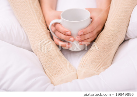 Nice woman warming her legs Nice woman warming her legs 19849896