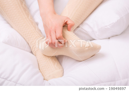Nice woman warming her legs Nice woman warming her legs 19849897