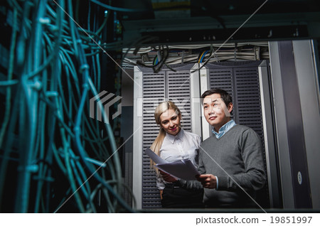 Young engineers businessmen in server room Young engineers businessmen in server room 19851997