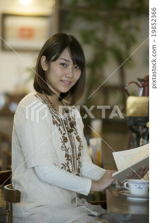 A woman reading at a cafe A woman reading at a cafe 19852366