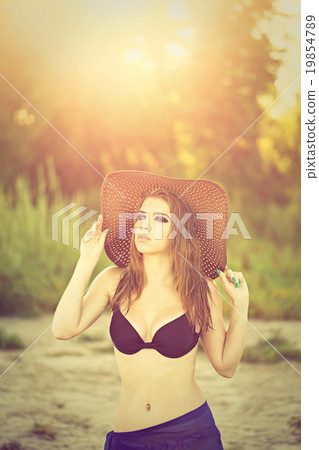 Girl in a bikini on the beach. 19854789