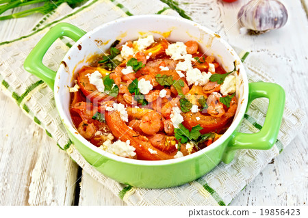 Shrimp and tomatoes with feta in green pan 19856423