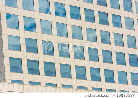 blue sky and clouds reflected in office building 19856557