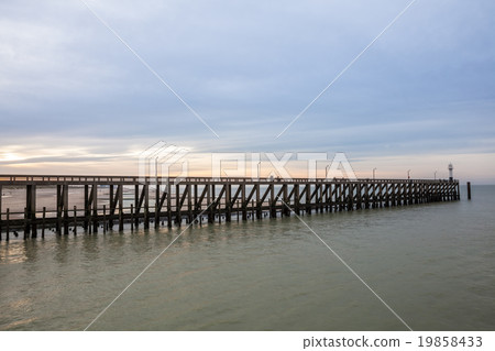 the pier whit light pole at the sea the pier whit light pole at the sea 19858433