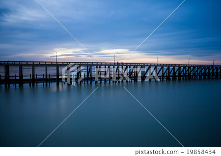 the pier whit light pole at the sea the pier whit light pole at the sea 19858434