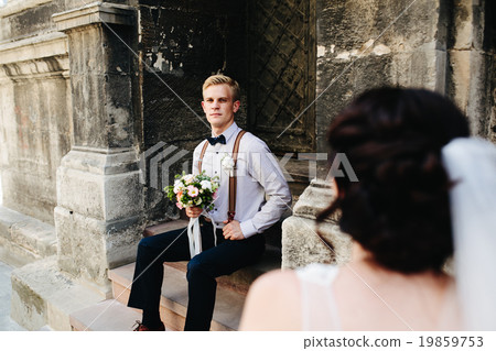 bride sitting on stone steps 19859753